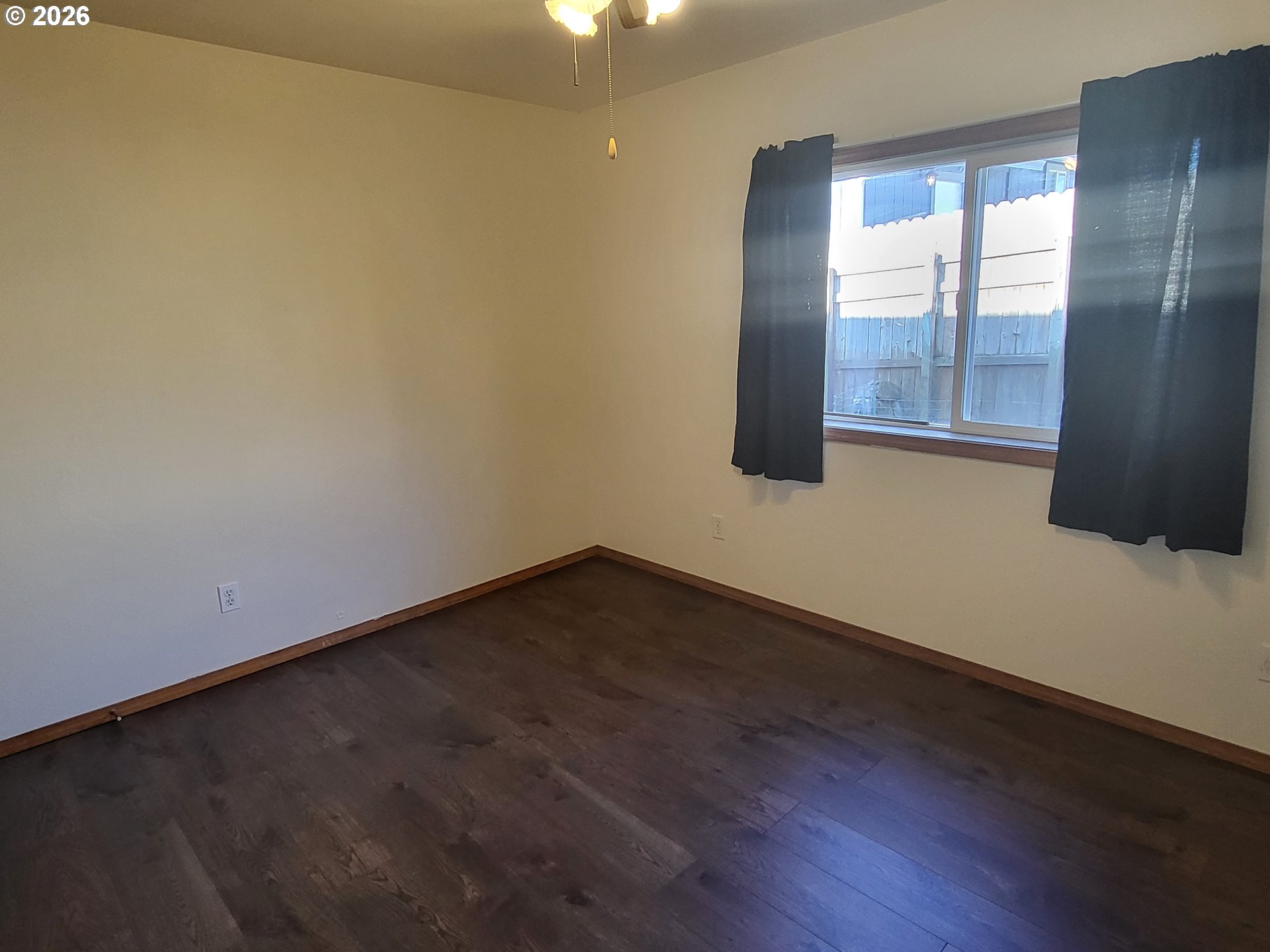 963 Crocker Street Coos Bay, OR 97420 - Photo 31 of 42 an empty room with wooden floor and windows
