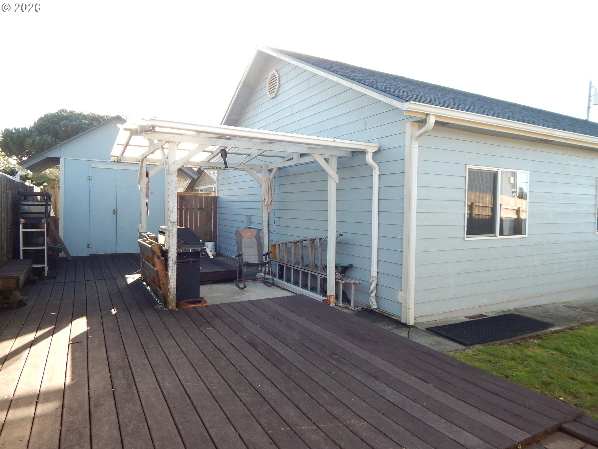 963 Crocker Street Coos Bay, OR 97420 - Photo 39 of 42 a view of a house with barbeque on wooden floor