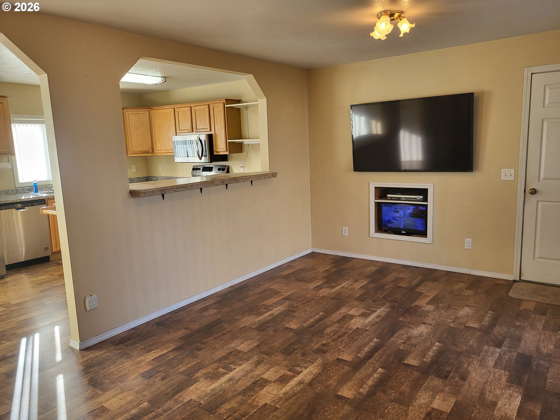 963 Crocker Street Coos Bay, OR 97420 - Photo 6 of 42 a view of a livingroom with wooden floor and a flat screen tv