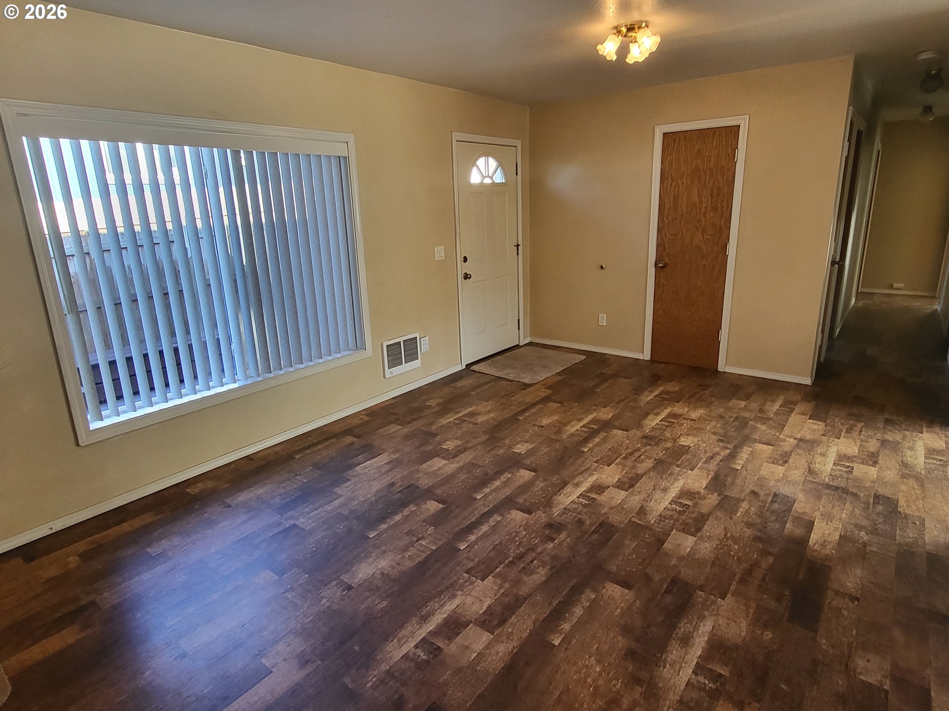 963 Crocker Street Coos Bay, OR 97420 - Photo 7 of 42 an empty room with wooden floor and windows