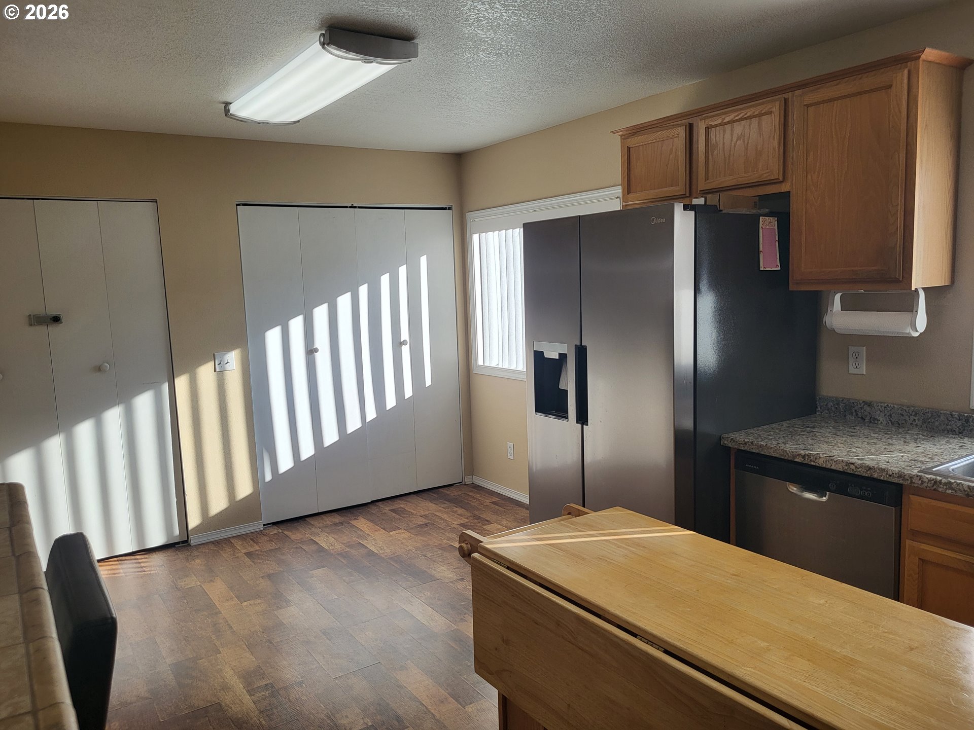 963 Crocker Street Coos Bay, OR 97420 - Photo 10 of 42 a kitchen with granite countertop a refrigerator and a sink