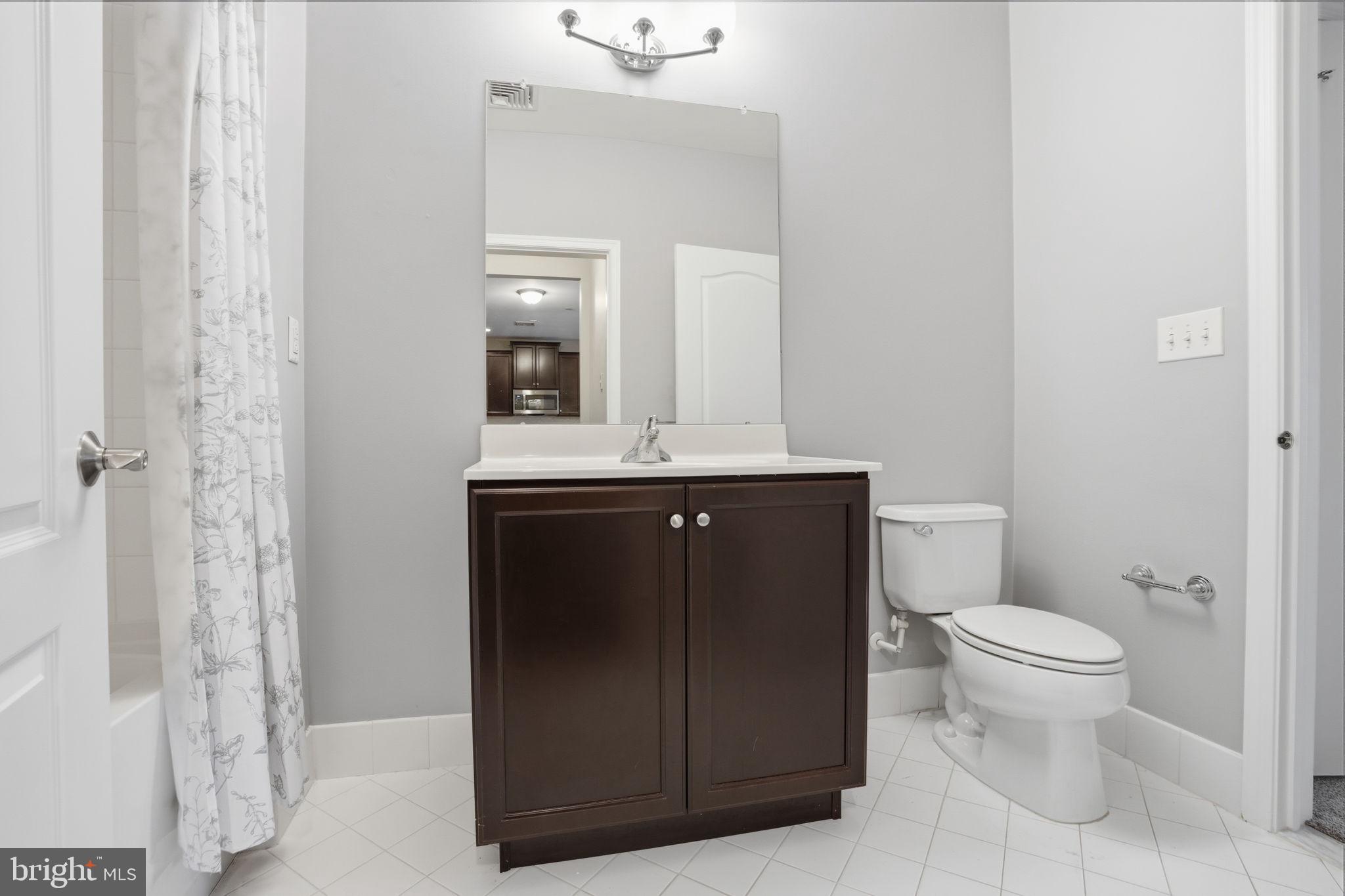 235 Carson Terrace Huntingdon Valley, PA 19006 - Photo 7 of 23 a bathroom with a granite countertop sink a toilet mirror and vanity