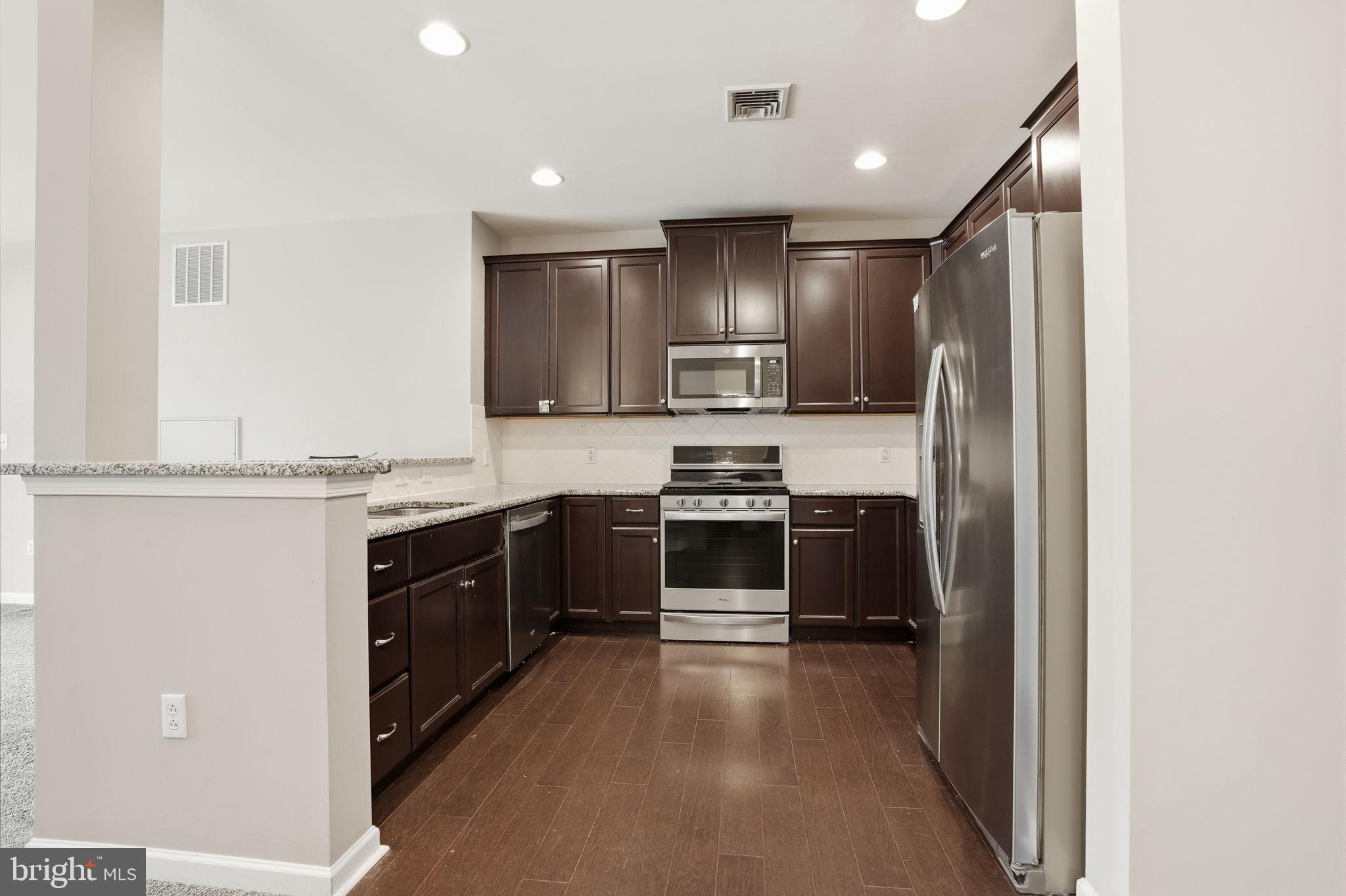 235 Carson Terrace Huntingdon Valley, PA 19006 - Photo 10 of 23 a large kitchen with a refrigerator and a stove top oven
