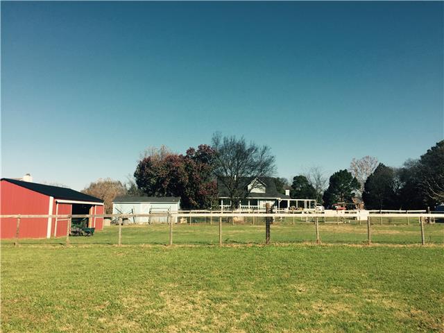 1230 Northwest Rutland Road Mount Juliet, TN 37122 - Photo 18 of 20 Barn, storage building, and fencing in rear for all the animals.