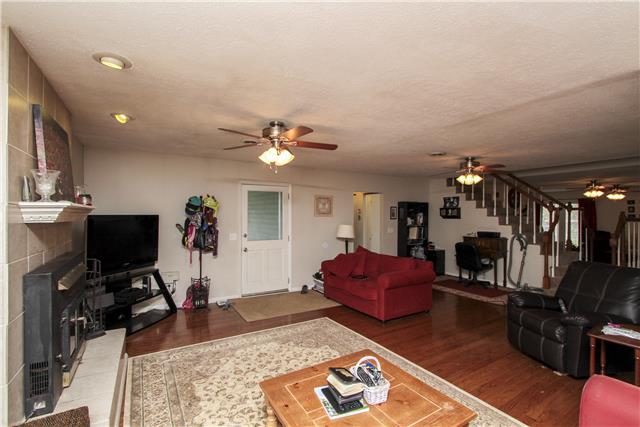 1230 Northwest Rutland Road Mount Juliet, TN 37122 - Photo 5 of 20 Spacious den that features a fireplace with a wood burning insert, hardwood floors too.