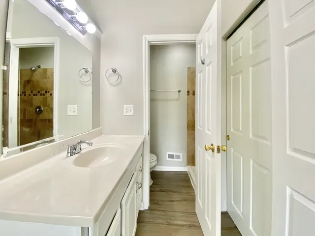 a spacious bathroom with a sink and mirror