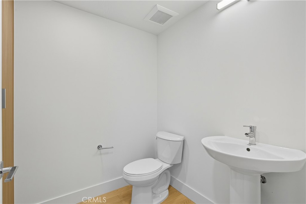 12078 Guerin Street, Unit 405 Studio City, CA 91604 - Photo 13 of 21 a bathroom with a sink a toilet and a mirror