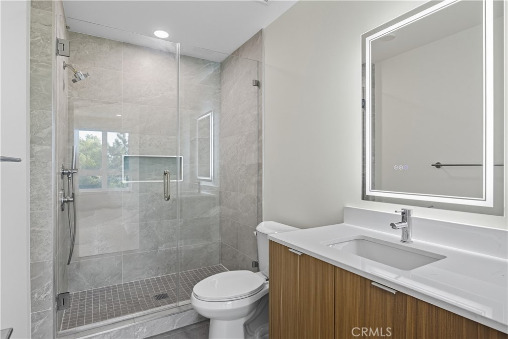 12078 Guerin Street, Unit 405 Studio City, CA 91604 - Photo 18 of 21 a bathroom with a granite countertop sink toilet and shower
