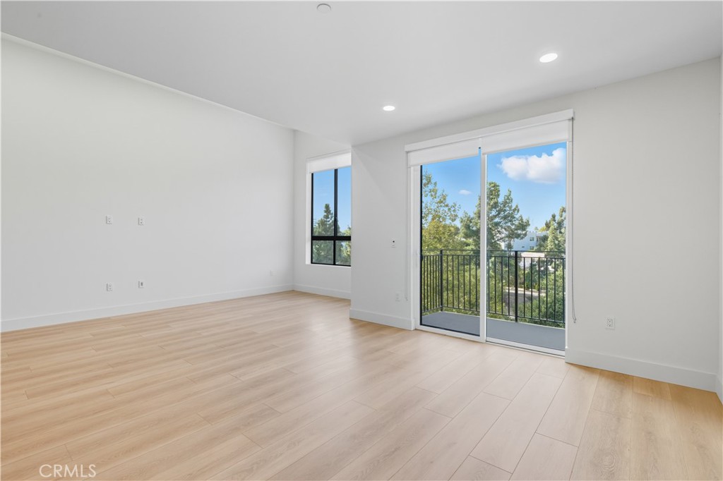 12078 Guerin Street, Unit 405 Studio City, CA 91604 - Photo 3 of 21 a view of an empty room with wooden floor and a window