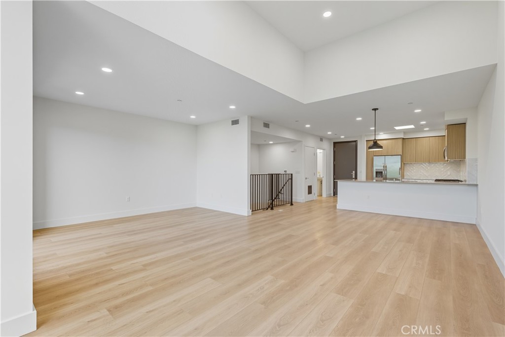12078 Guerin Street, Unit 405 Studio City, CA 91604 - Photo 7 of 21 a view of large kitchen with white the kitchen island wooden floor and kitchen island