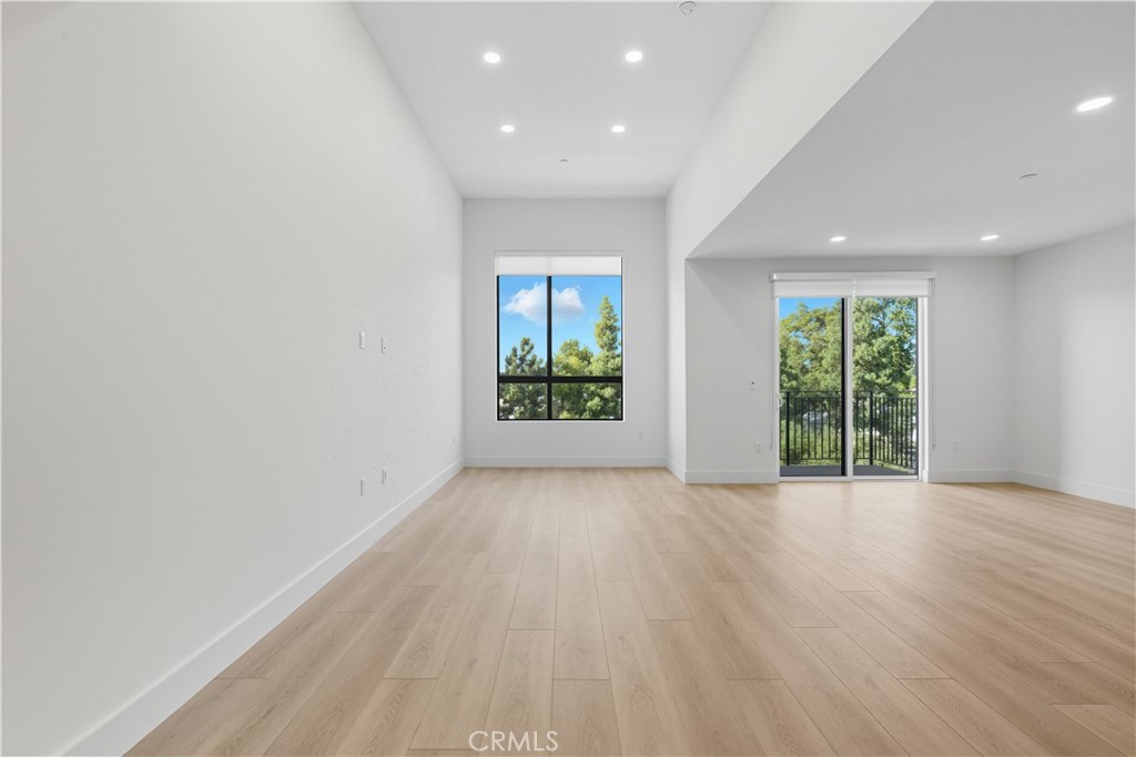12078 Guerin Street, Unit 405 Studio City, CA 91604 - Photo 8 of 21 an empty room with wooden floor and windows