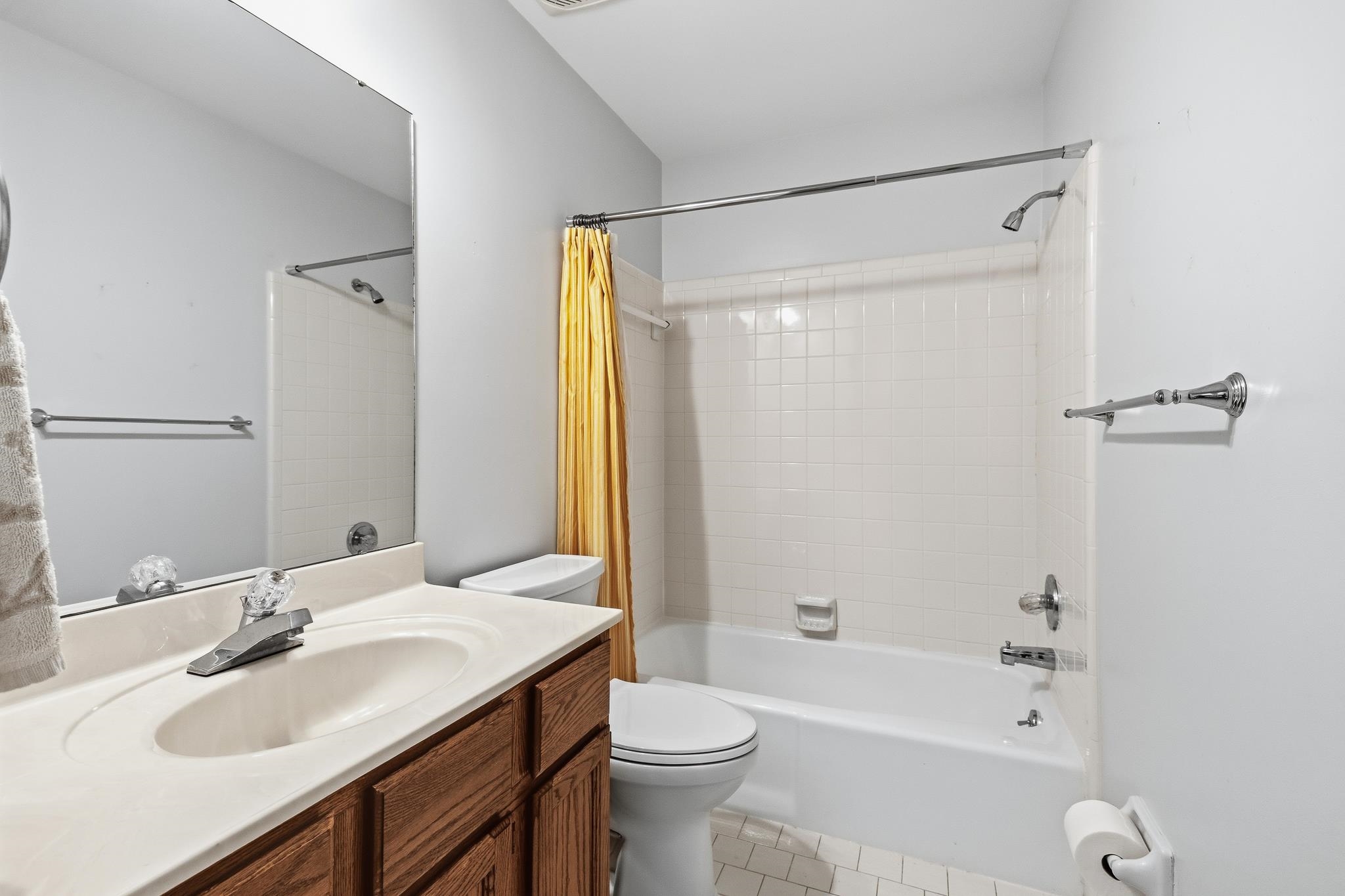 1889 Allenby Road Germantown, TN 38139 - Photo 22 of 26 Spa-inspired bathroom featuring a wood-finish vanity with dual sink basin, white quartz countertop, and chrome fixtures