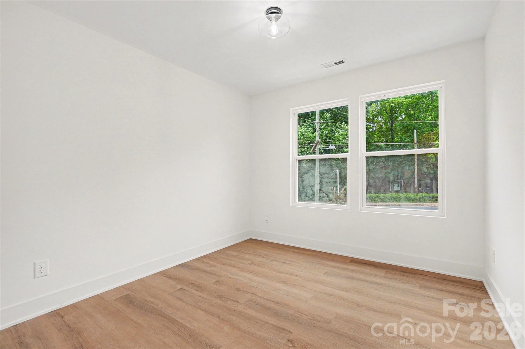 7521 Lawyers Road Charlotte, NC 28227 - Photo 22 of 35 an empty room with wooden floor and windows