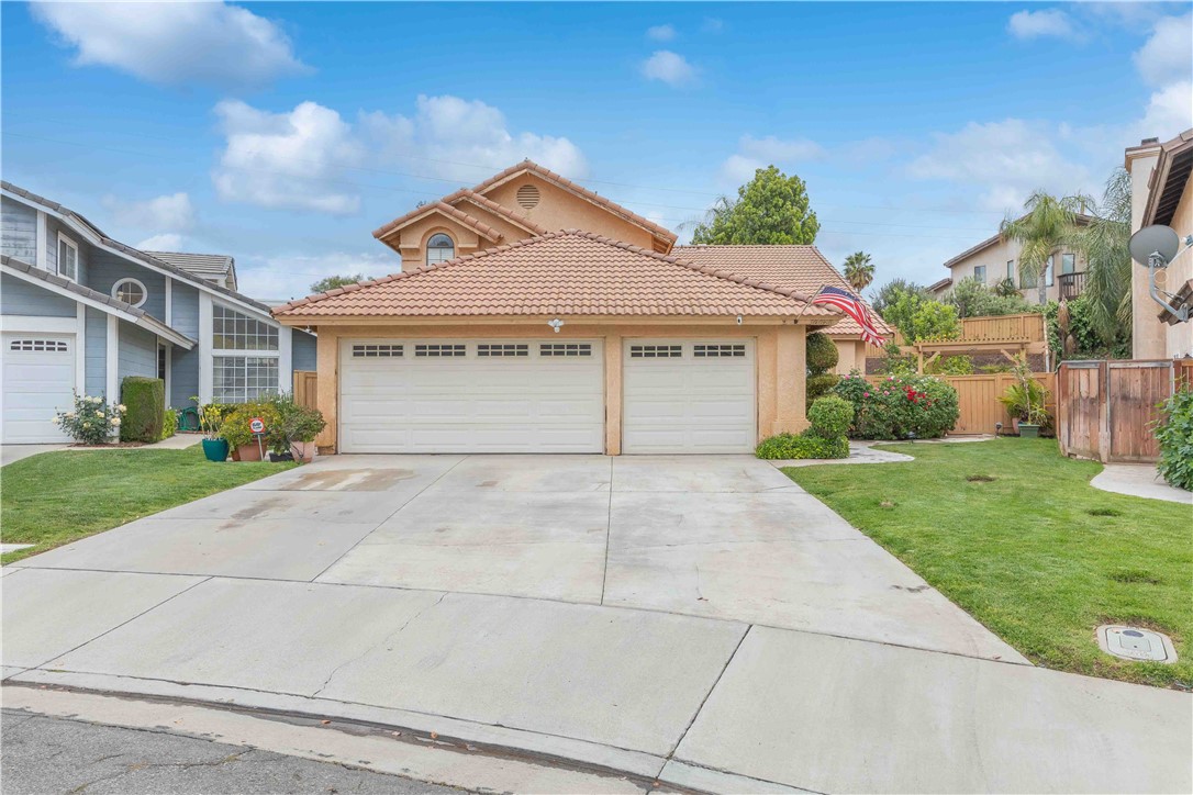 10628 Ridgefield Terrace Moreno Valley, CA 92557 - Photo 1 of 1 a front view of a house with a yard and garage