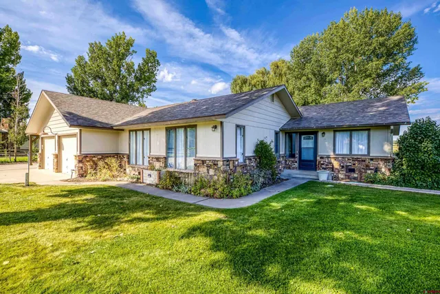 a front view of a house with swimming pool having outdoor seating