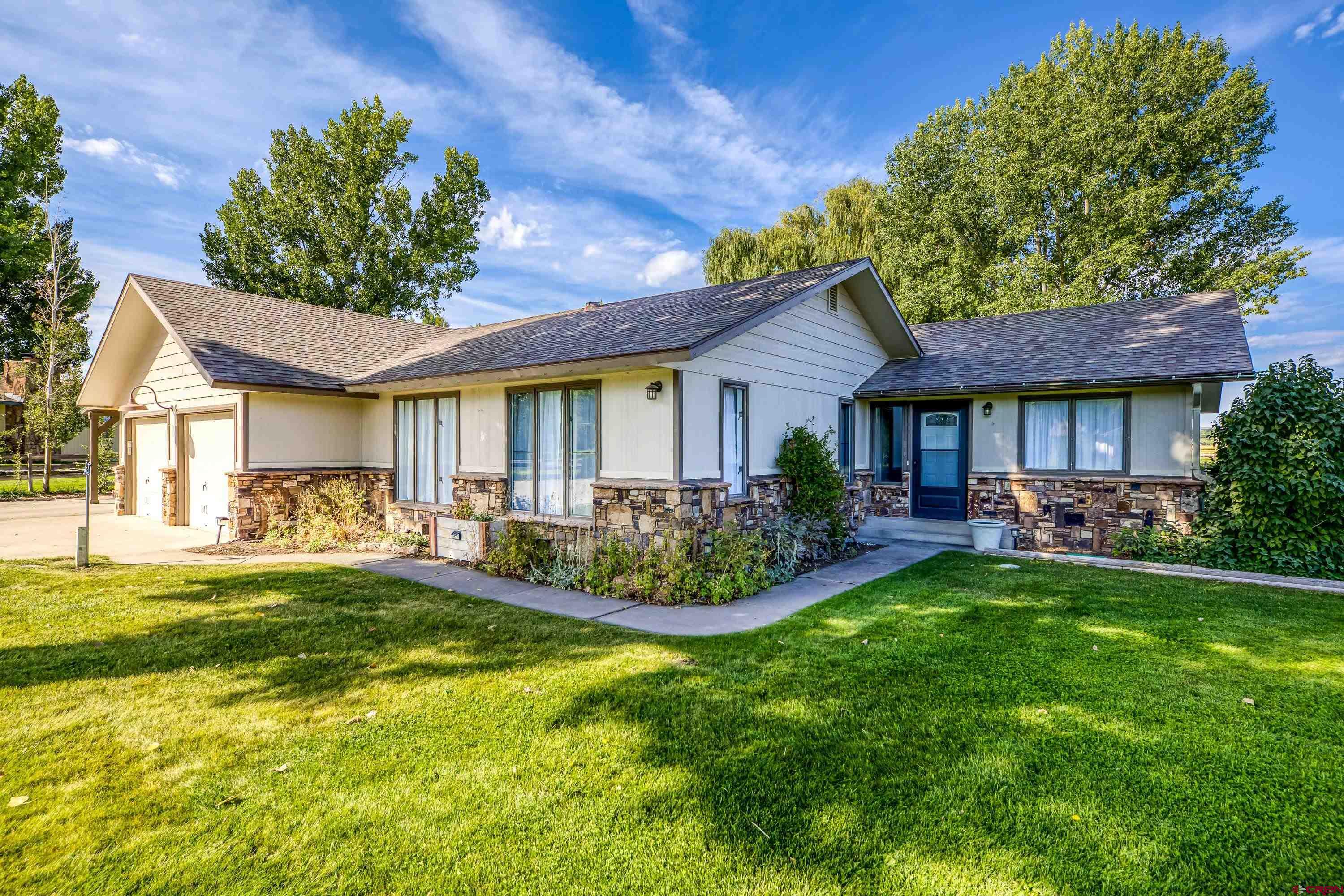a front view of a house with swimming pool having outdoor seating