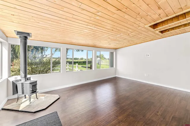 a dining room with wooden floor and furniture