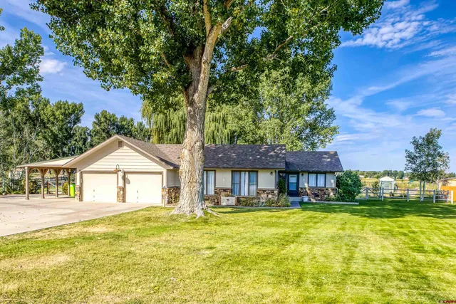 a front view of a house with swimming pool having outdoor seating