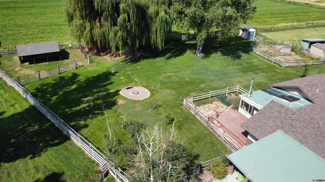 a view of a backyard with sitting area