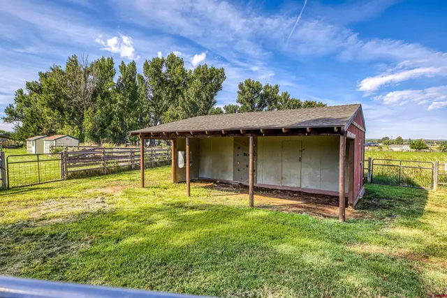 a view of a backyard with swimming pool