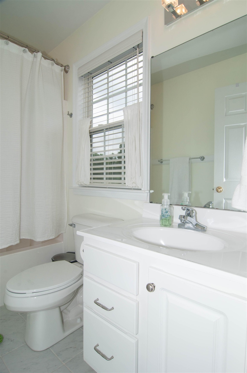 1265 Amber Ridge Road Charlottesville, VA 22901 - Photo 32 of 44 a bathroom with a granite countertop toilet a sink a mirror and a window
