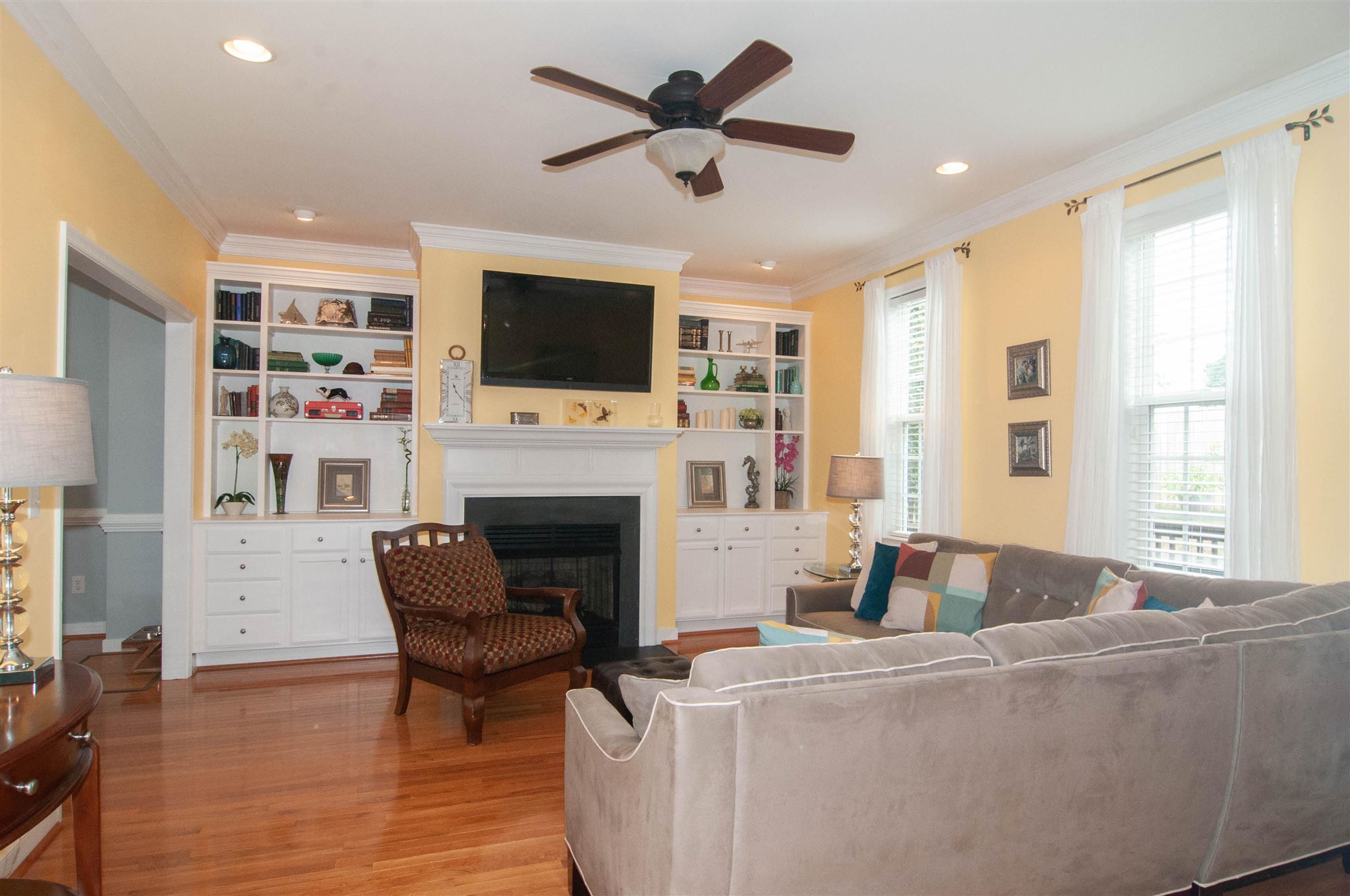 1265 Amber Ridge Road Charlottesville, VA 22901 - Photo 5 of 44 a living room with furniture a flat screen tv and a fireplace