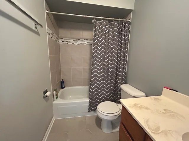 a bathroom with a toilet a sink and a shower