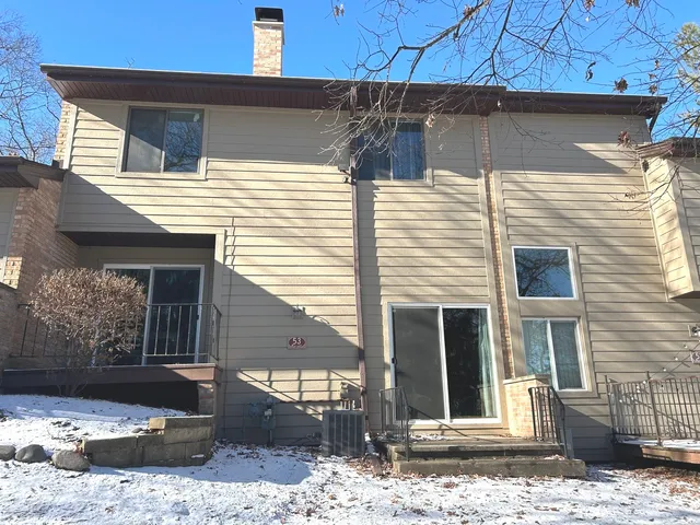 a view of a house with a door and wooden fence