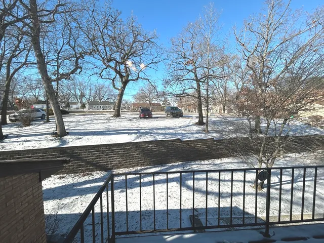 a view of a yard with wooden fence