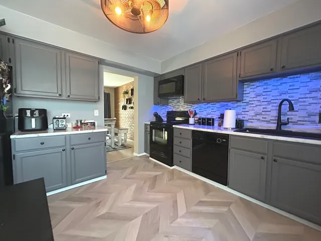 a kitchen with stainless steel appliances granite countertop a sink and cabinets