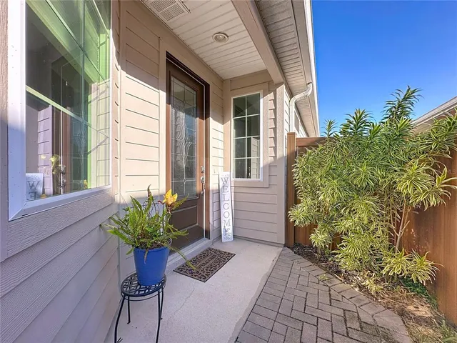 a kitchen with stainless steel appliances granite countertop a refrigerator a stove a sink a table and chairs