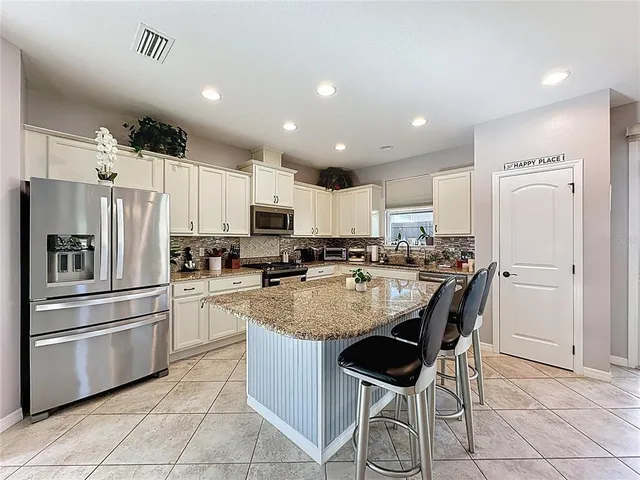 a living room with furniture and kitchen view