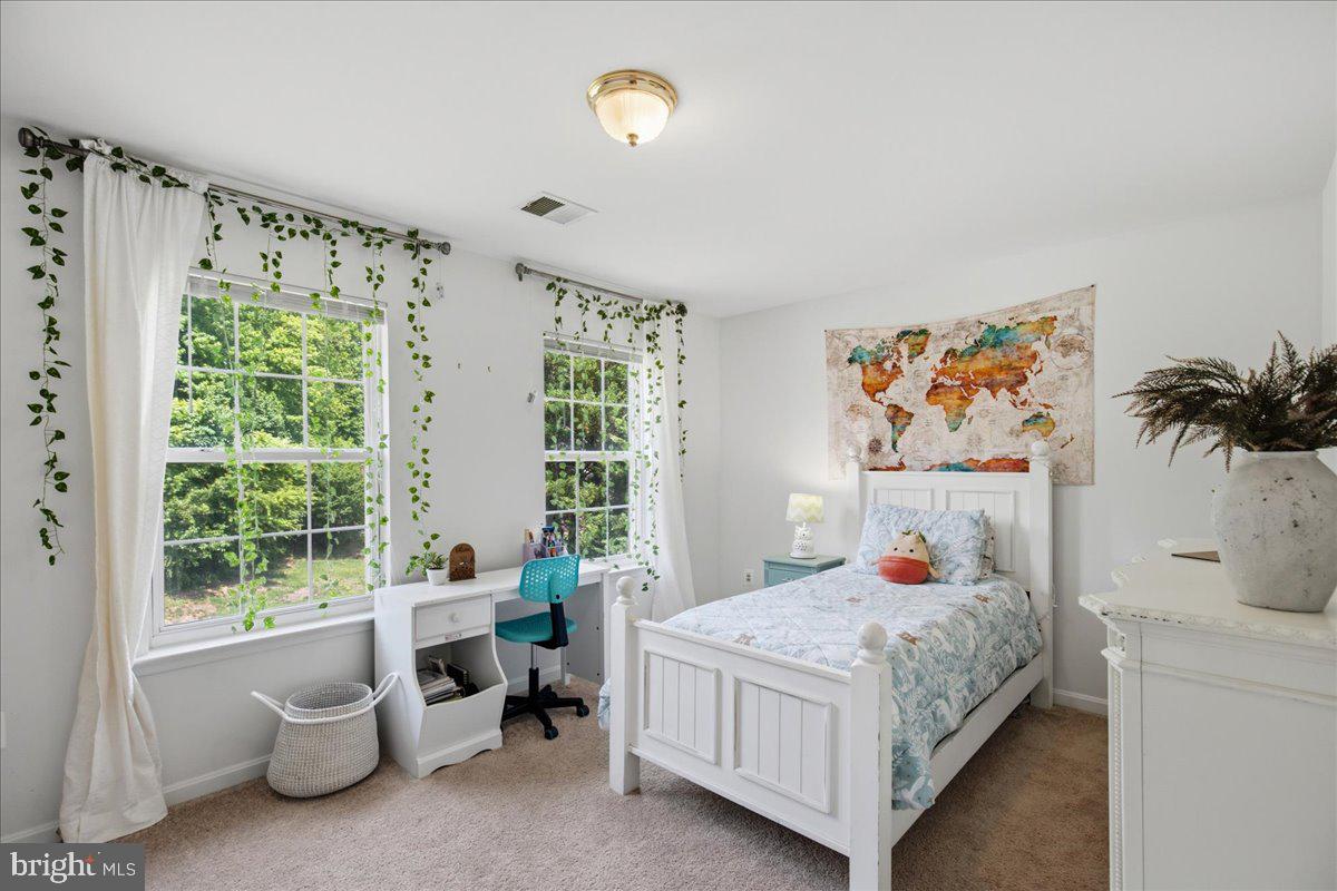2424 Springbrook Court Huntingtown, MD 20639 - Photo 63 of 103 a bedroom with a bed and a table