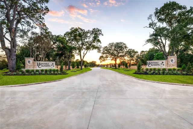 a view of a house with a big yard and large trees
