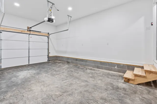 a bathroom with a granite countertop sink a toilet a mirror and bathtub