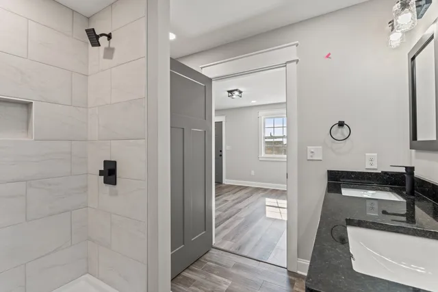 a kitchen with granite countertop white cabinets and stainless steel appliances