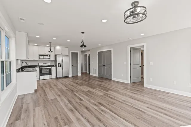 a bathroom with a granite countertop sink a toilet and a mirror
