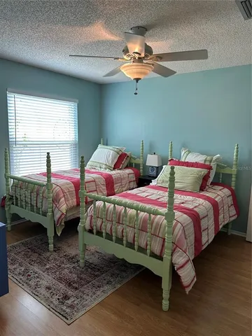 a bedroom with two beds and a chandelier