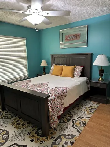 a bedroom with a bed and a chandelier