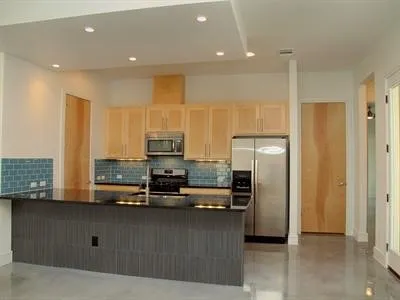 a kitchen with stainless steel appliances a refrigerator and microwave
