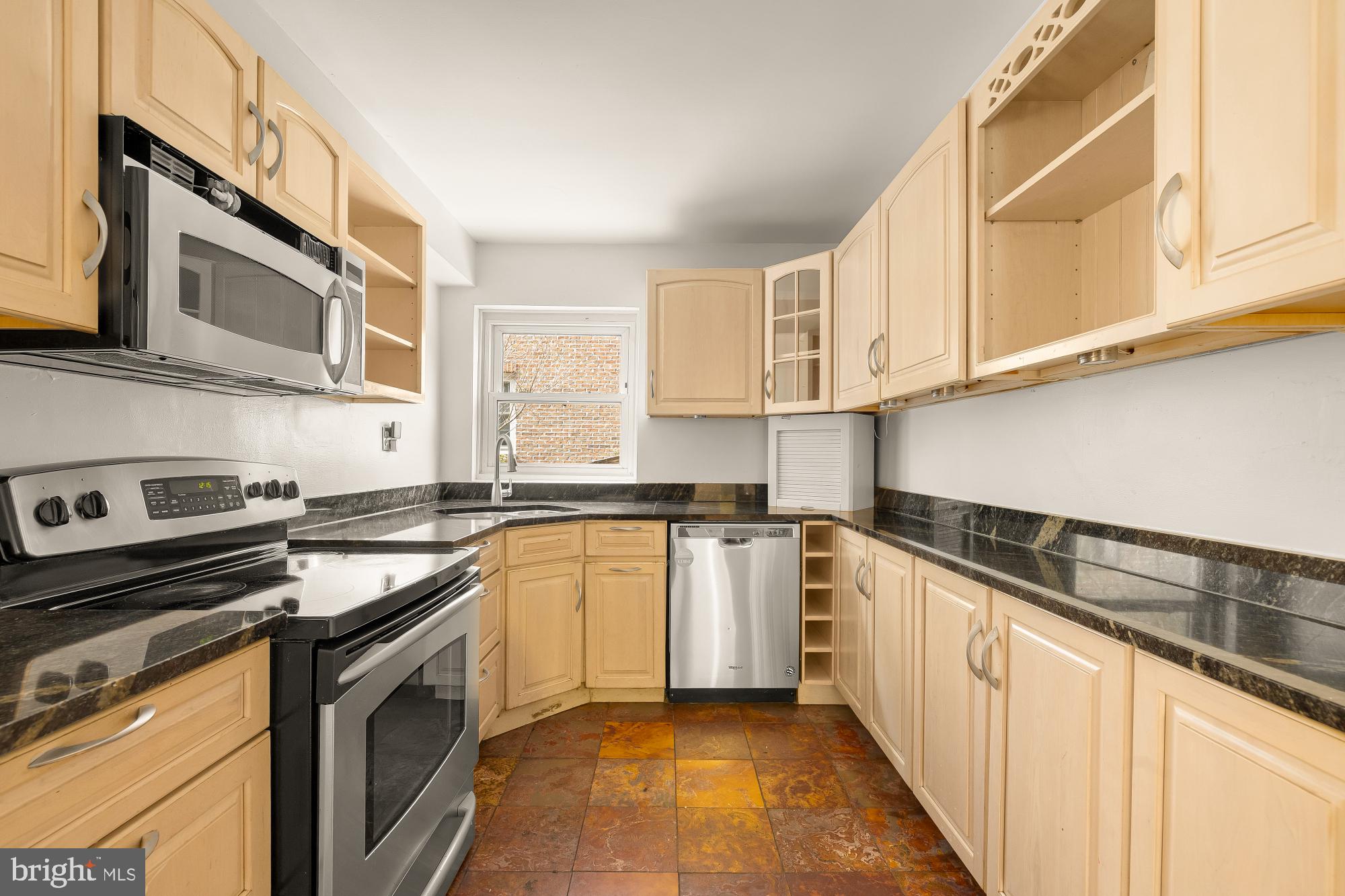 6112 Madawaska Road Bethesda, MD 20816 - Photo 15 of 56 a kitchen with stainless steel appliances granite countertop a sink stove and microwave