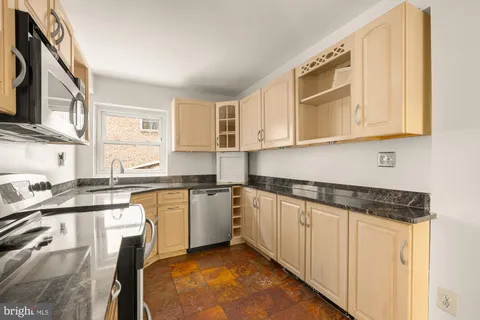a kitchen with stainless steel appliances granite countertop a stove and a refrigerator