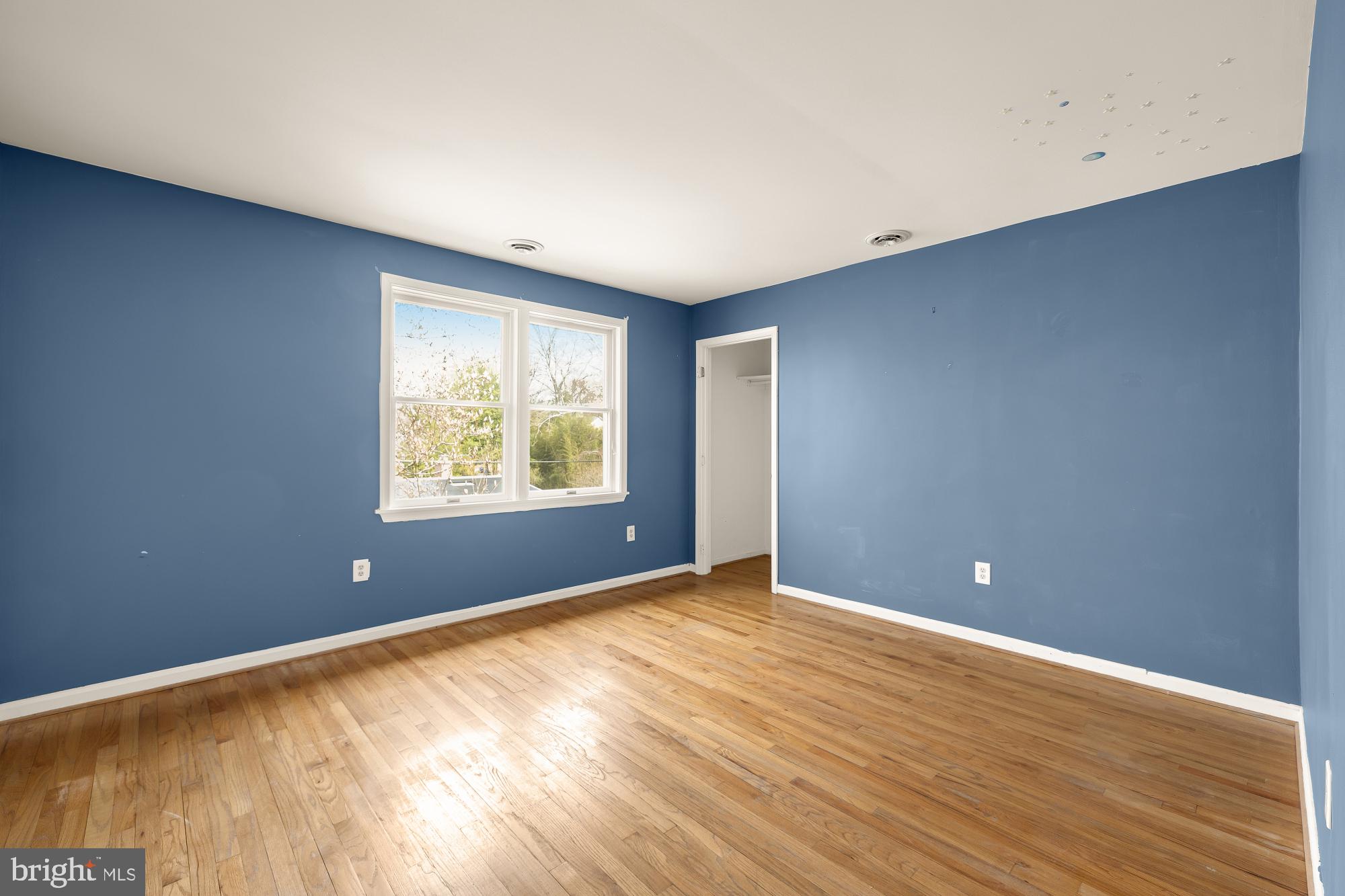 6112 Madawaska Road Bethesda, MD 20816 - Photo 24 of 56 a view of an empty room with wooden floor and a window