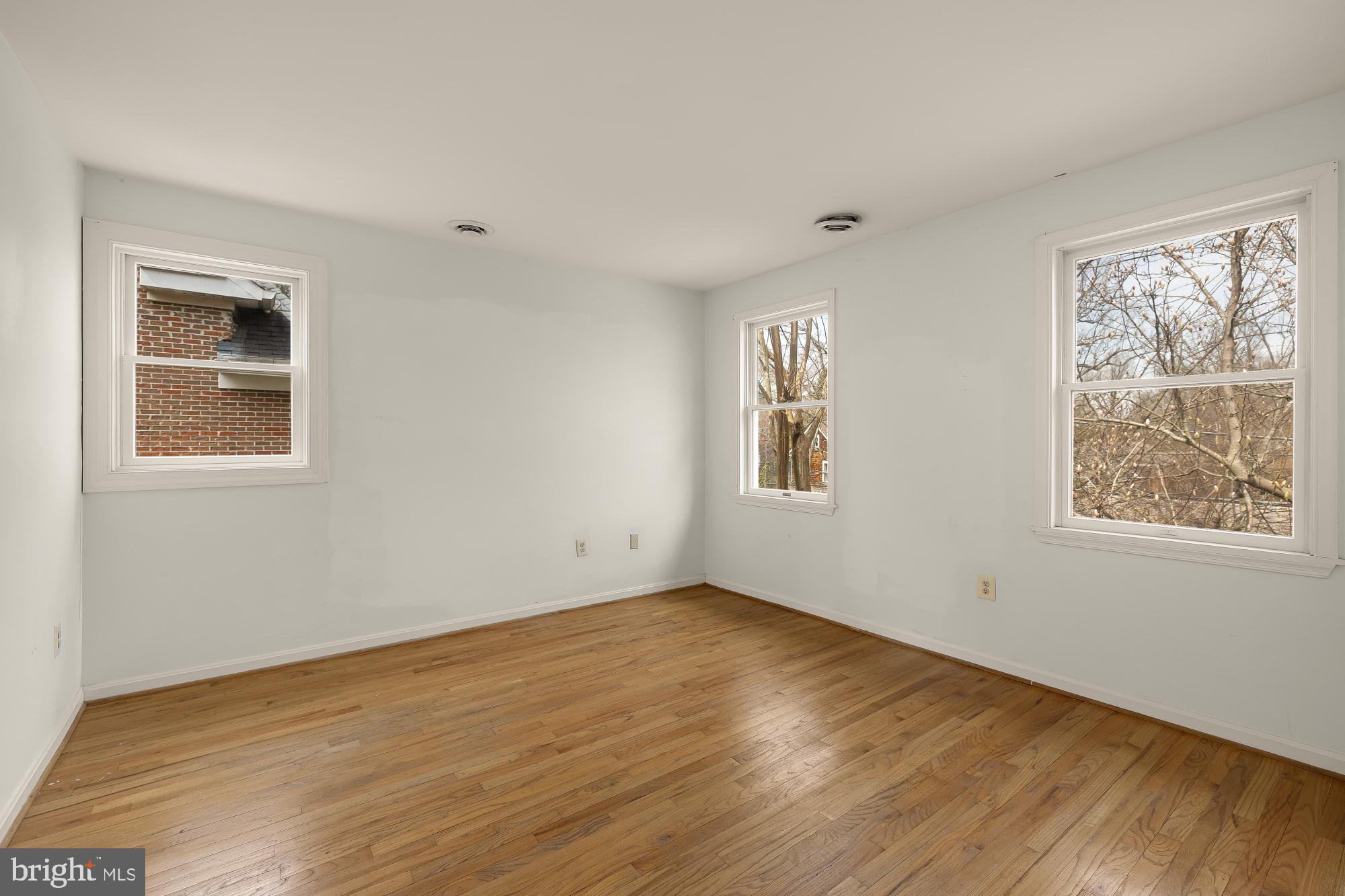 6112 Madawaska Road Bethesda, MD 20816 - Photo 26 of 56 a view of an empty room with wooden floor and a window