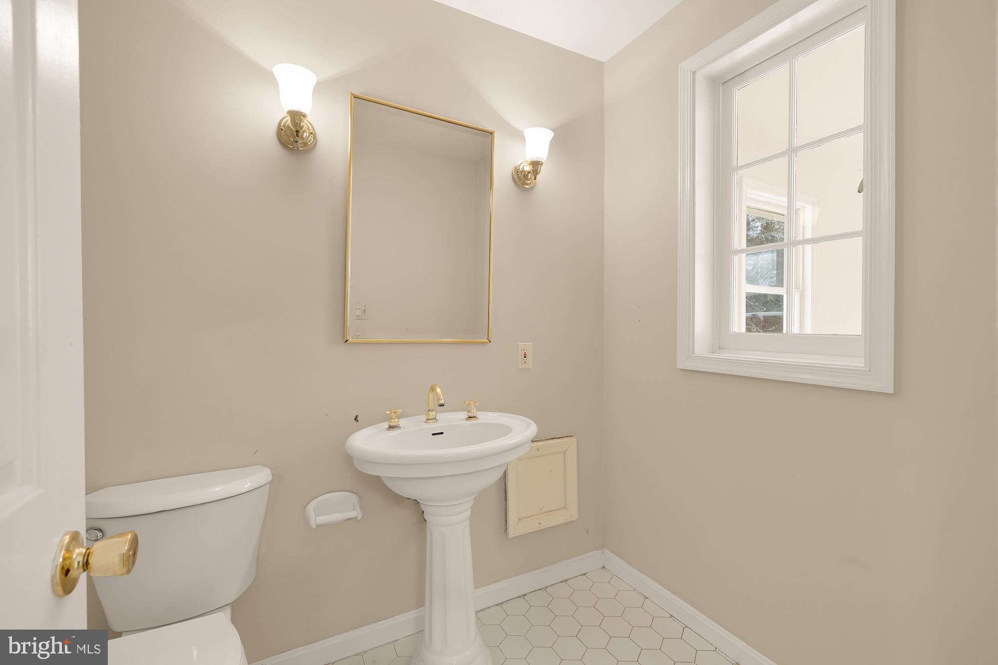 6112 Madawaska Road Bethesda, MD 20816 - Photo 29 of 56 a bathroom with a sink toilet and mirror