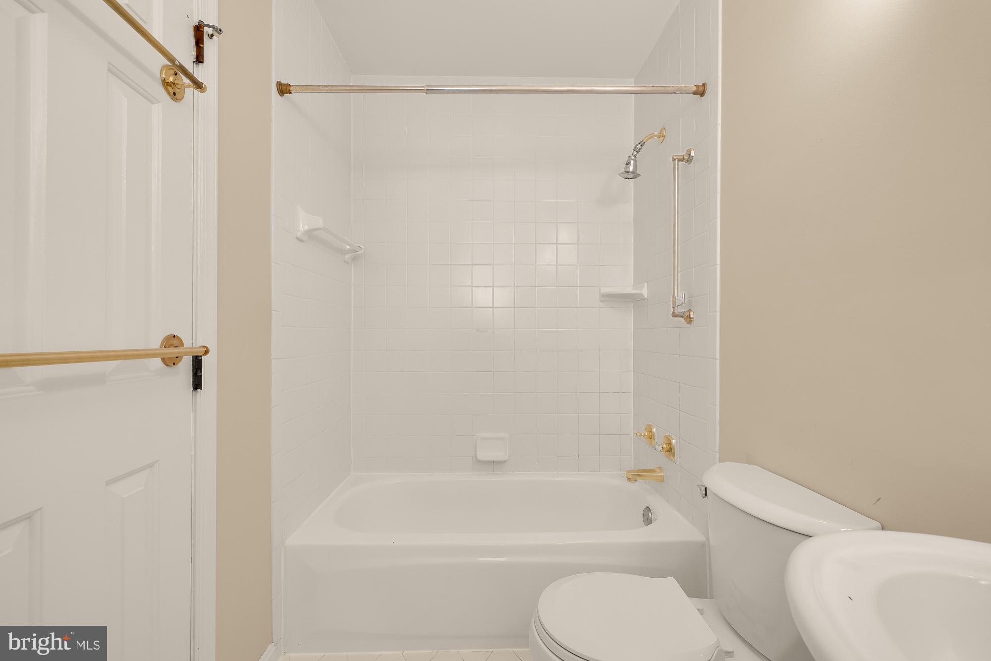 6112 Madawaska Road Bethesda, MD 20816 - Photo 30 of 56 a bathroom with a toilet and a bath tub