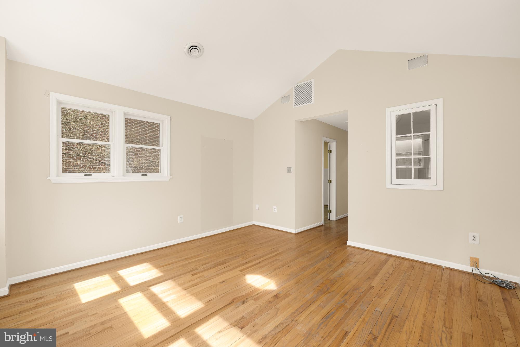 6112 Madawaska Road Bethesda, MD 20816 - Photo 33 of 56 a view of an empty room with wooden floor and a window