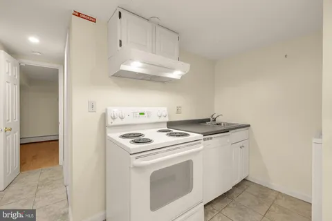 a view of a storage & utility room with a sink