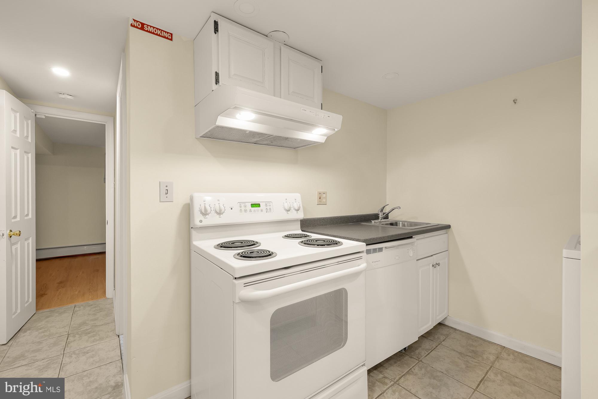 6112 Madawaska Road Bethesda, MD 20816 - Photo 35 of 56 a kitchen with a stove and a refrigerator