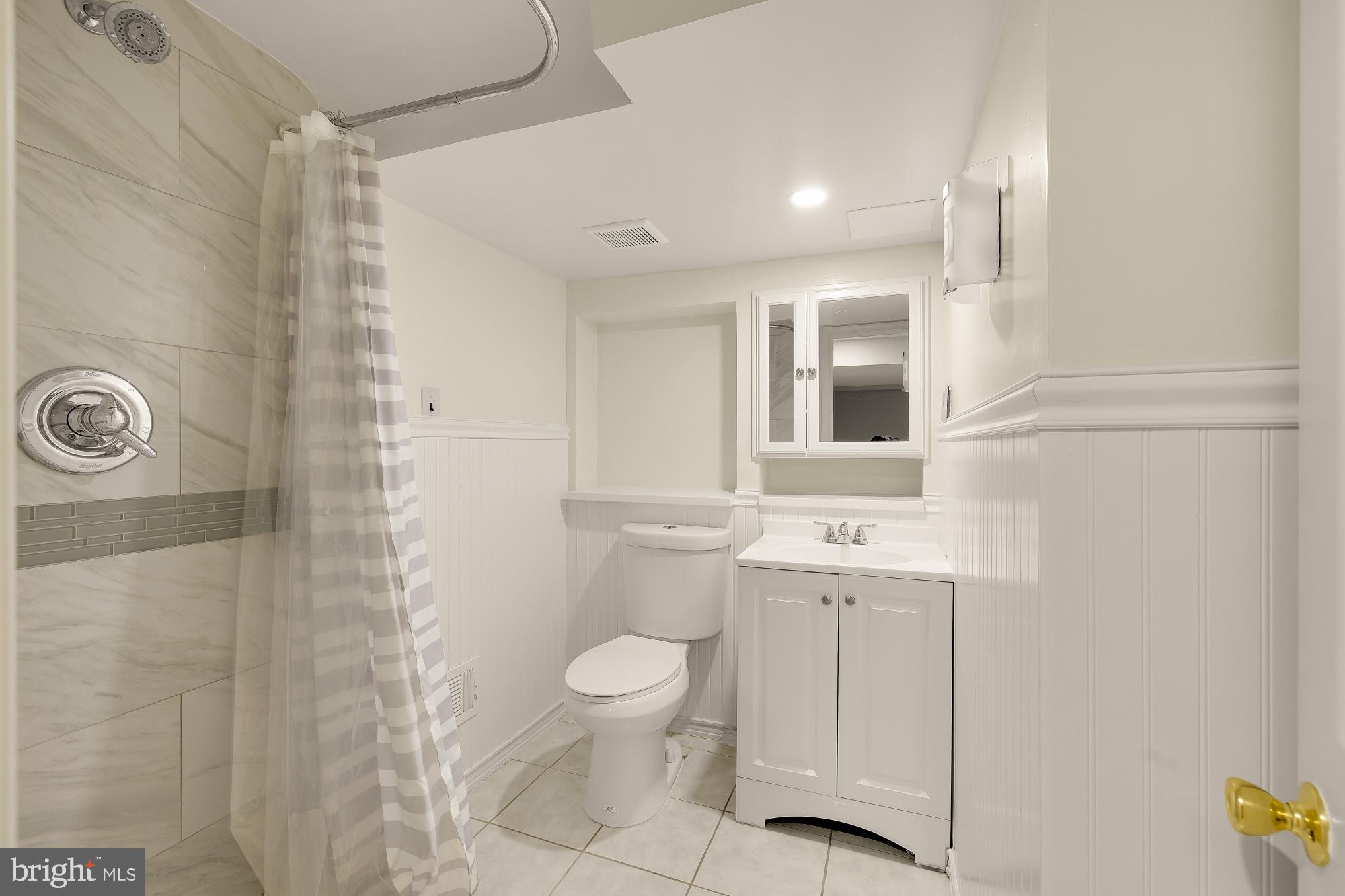 6112 Madawaska Road Bethesda, MD 20816 - Photo 40 of 56 a bathroom with a sink a toilet and shower